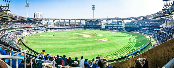 Cricket being played in front of a lot of people