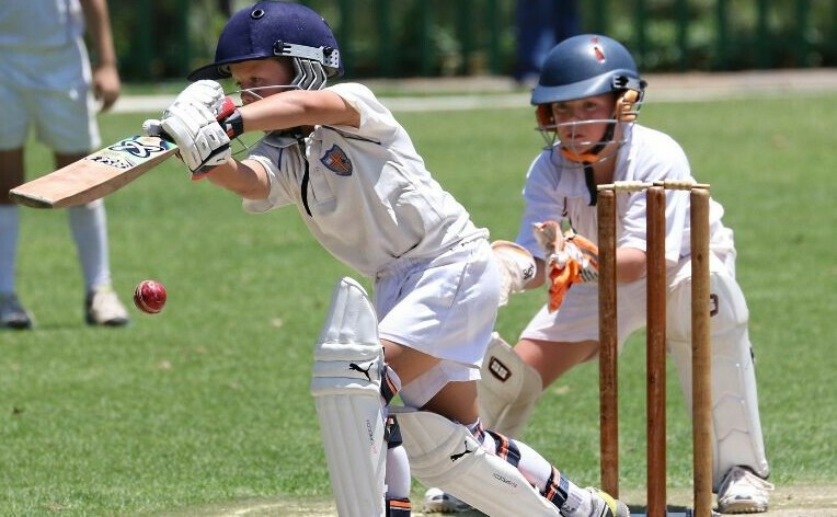 Young cricketers with crickat bat, pads and helmet