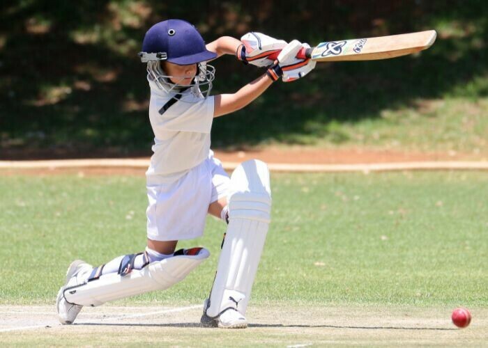 boy cricketer with helmet